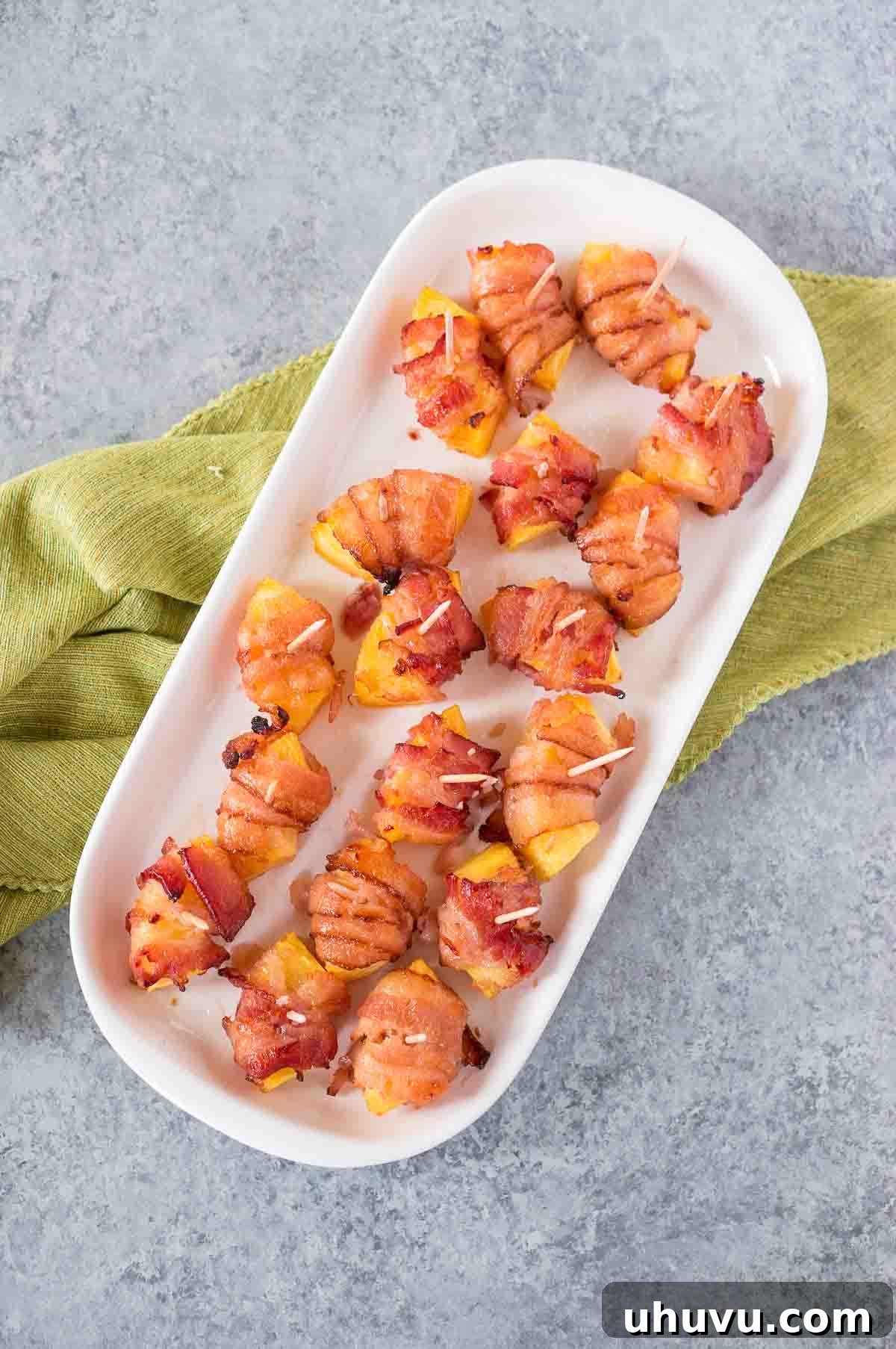 Sweet & Savory Bacon Pineapple Poppers 8 Beautifully arranged bacon pineapple bites on a serving platter