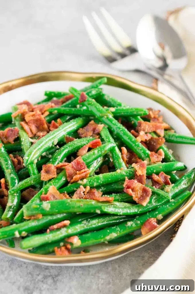 Crispy green beans with bacon on a white plate