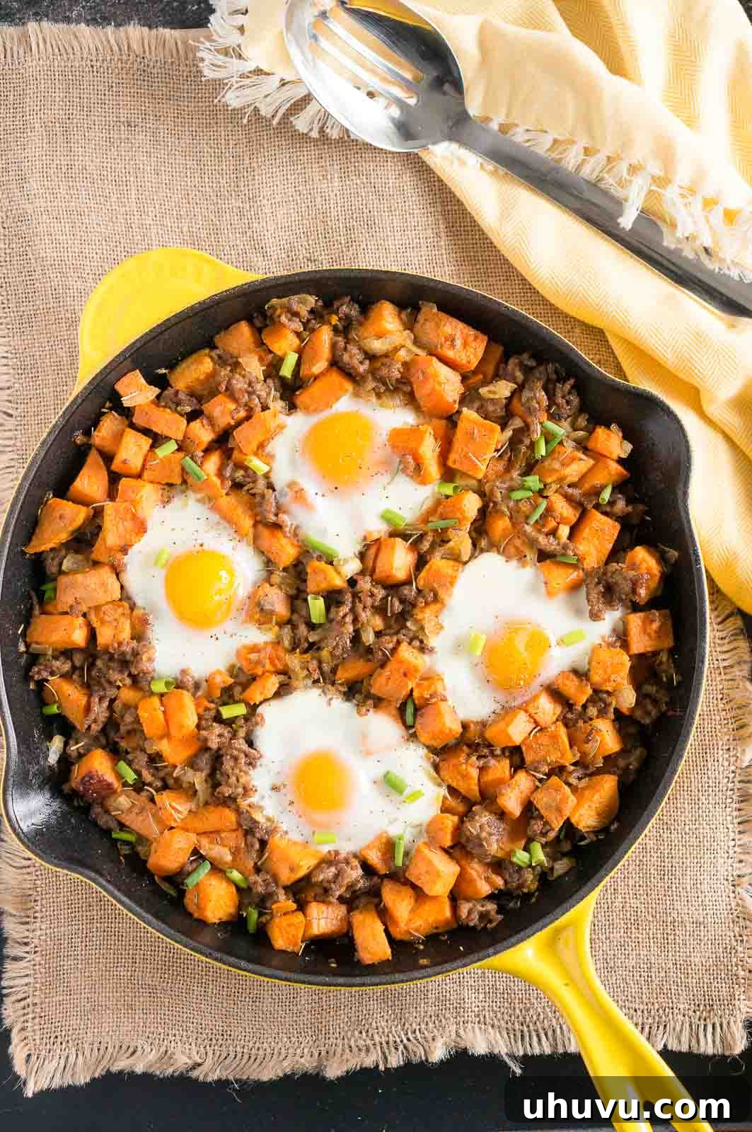 Delicious and healthy Sweet Potato Hash with Sausage and Eggs in a skillet