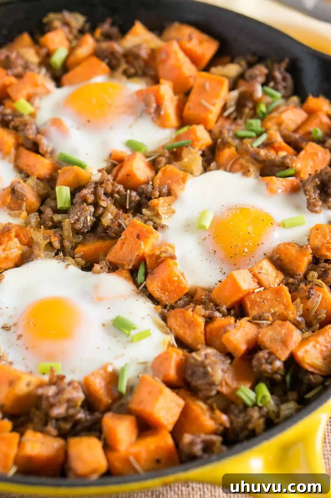 A close-up of the perfectly cooked Sweet Potato Hash with Sausage and Eggs