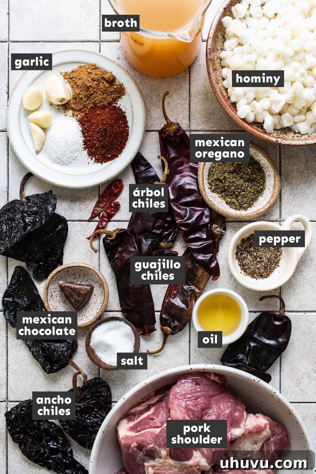All the vibrant ingredients needed for a delicious pozole rojo laid out neatly on a rustic wooden table, ready for preparation.