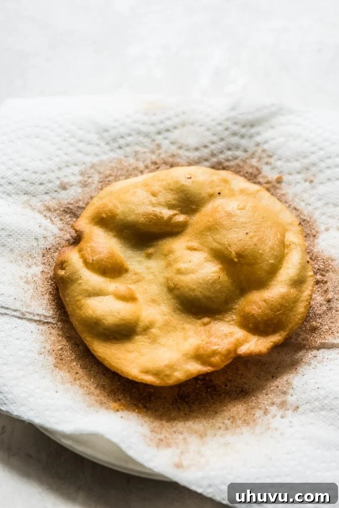 Crispy Cinnamon Sugar Buñuelos 5 Rolling out Buñuelos dough into thin circles
