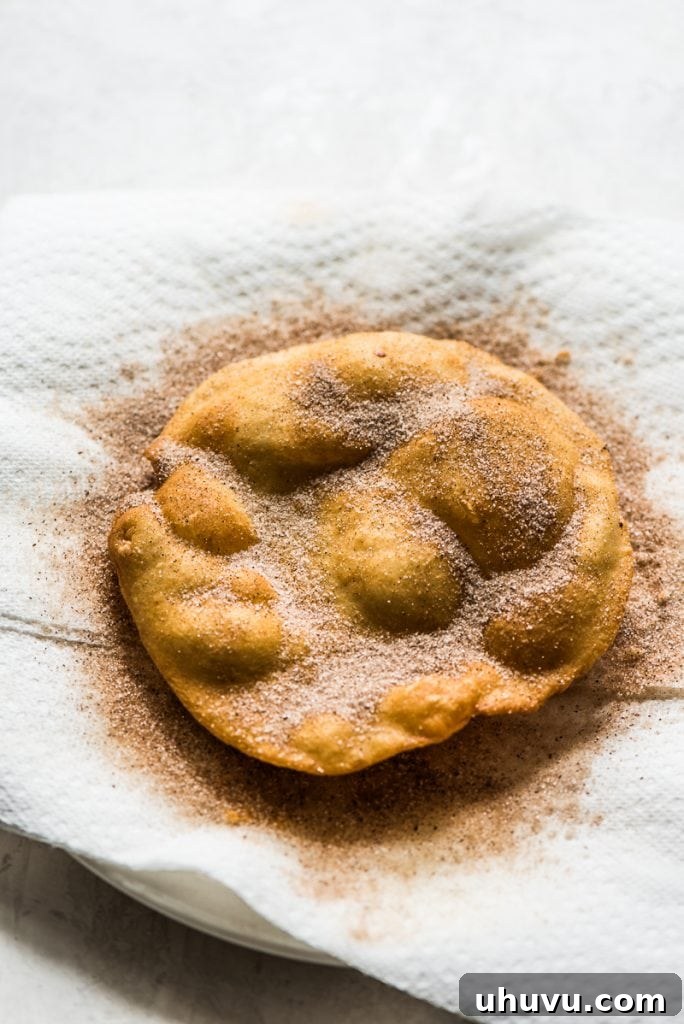 Crispy Cinnamon Sugar Buñuelos 6 Frying Mexican Buñuelos in hot oil