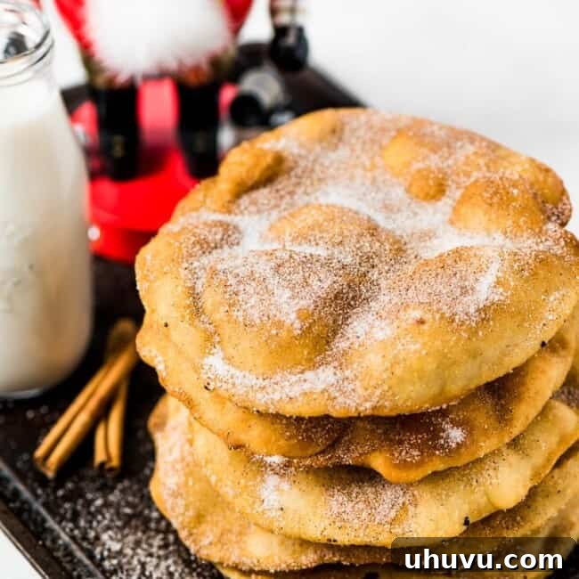 Crispy Mexican Buñuelos covered in cinnamon sugar, a traditional holiday dessert.