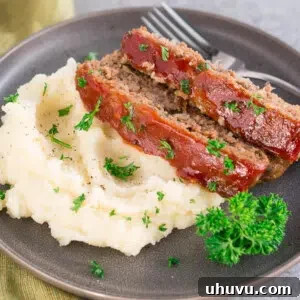 Classic Traditional Meatloaf recipe, sliced and served with a delicious glaze.
