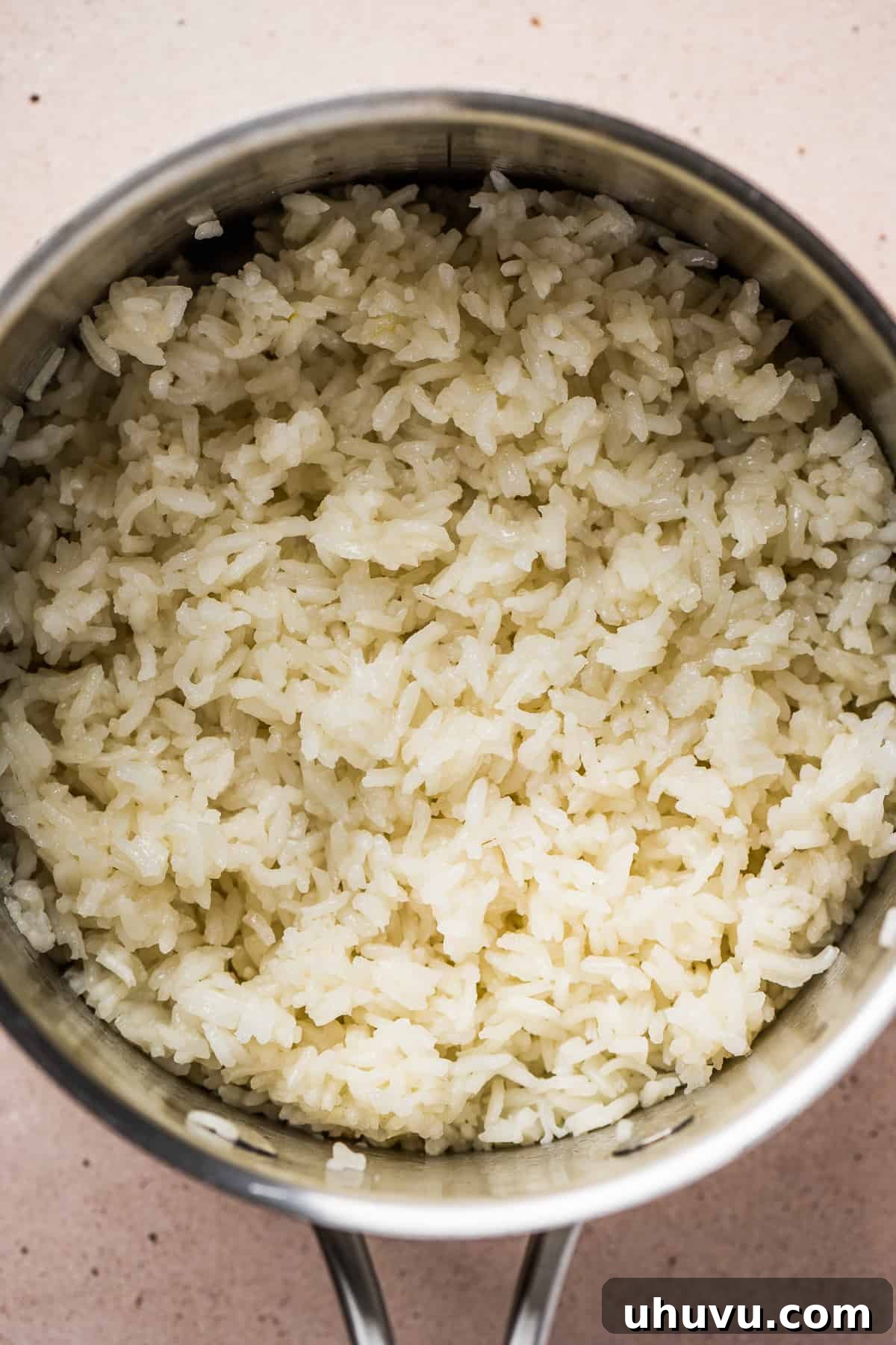 Cilantro Lime Rice Perfection 5 Rice cooking in a sauce pot with broth, garlic, and salt.