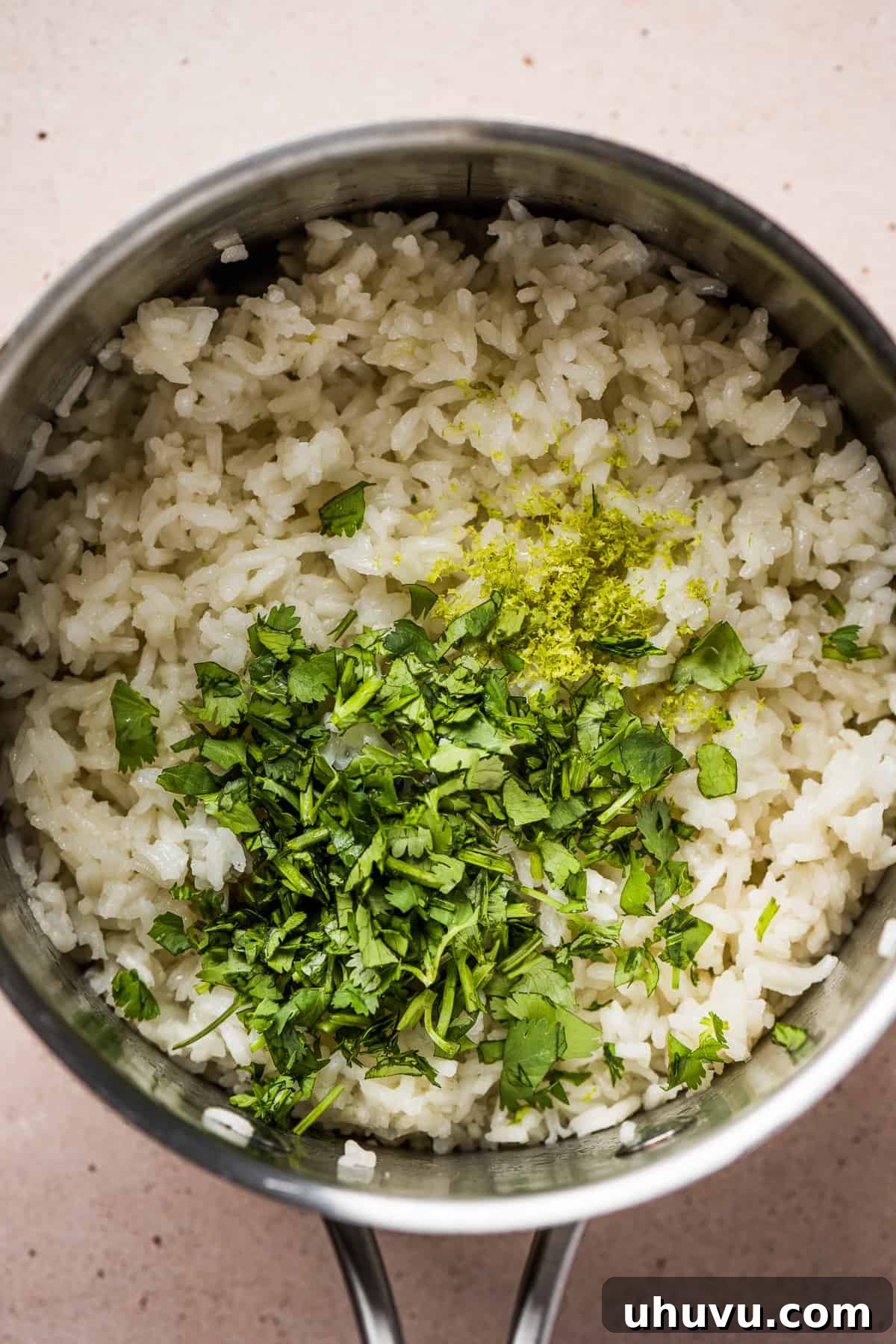 Cilantro Lime Rice Perfection 6 Cooked rice in a pot, topped with fresh cilantro, lime juice, and lime zest.