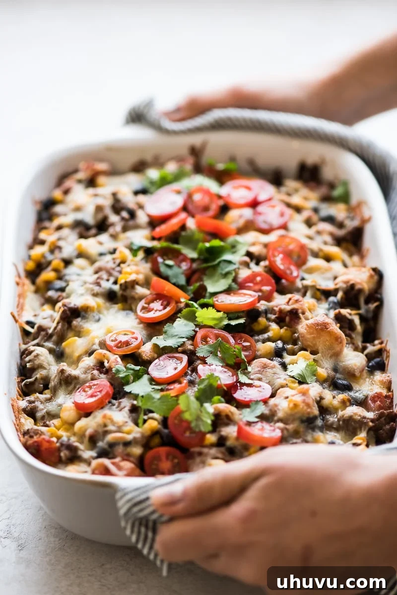Effortless Taco Delight 10 Baked Easy Taco Casserole topped with fresh cilantro and sour cream.