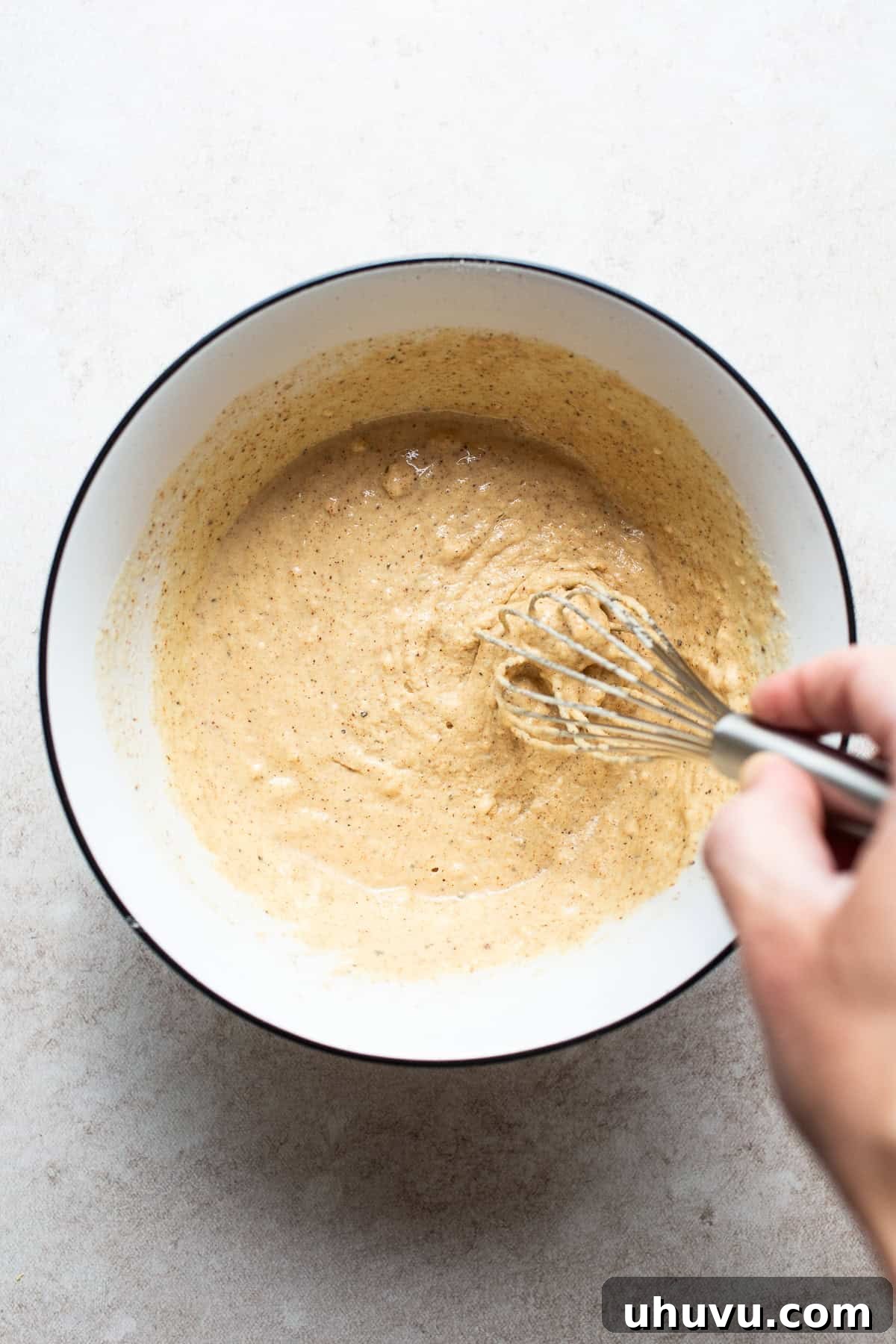 Golden Crispy Baja Fish Tacos 8 A bowl of light, bubbly beer batter being whisked, ready for coating the fish.