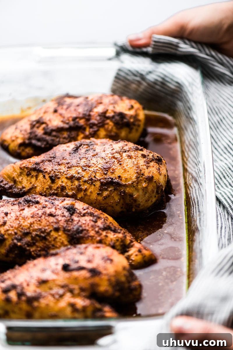 Weeknight Chipotle Chicken Delight 2 Chipotle chicken breasts in a baking dish. | If you love Chipotle Mexican Grill, you're going to love this copycat Chipotle Chicken Recipe! Made with a flavorful marinade and perfect for healthy meals!