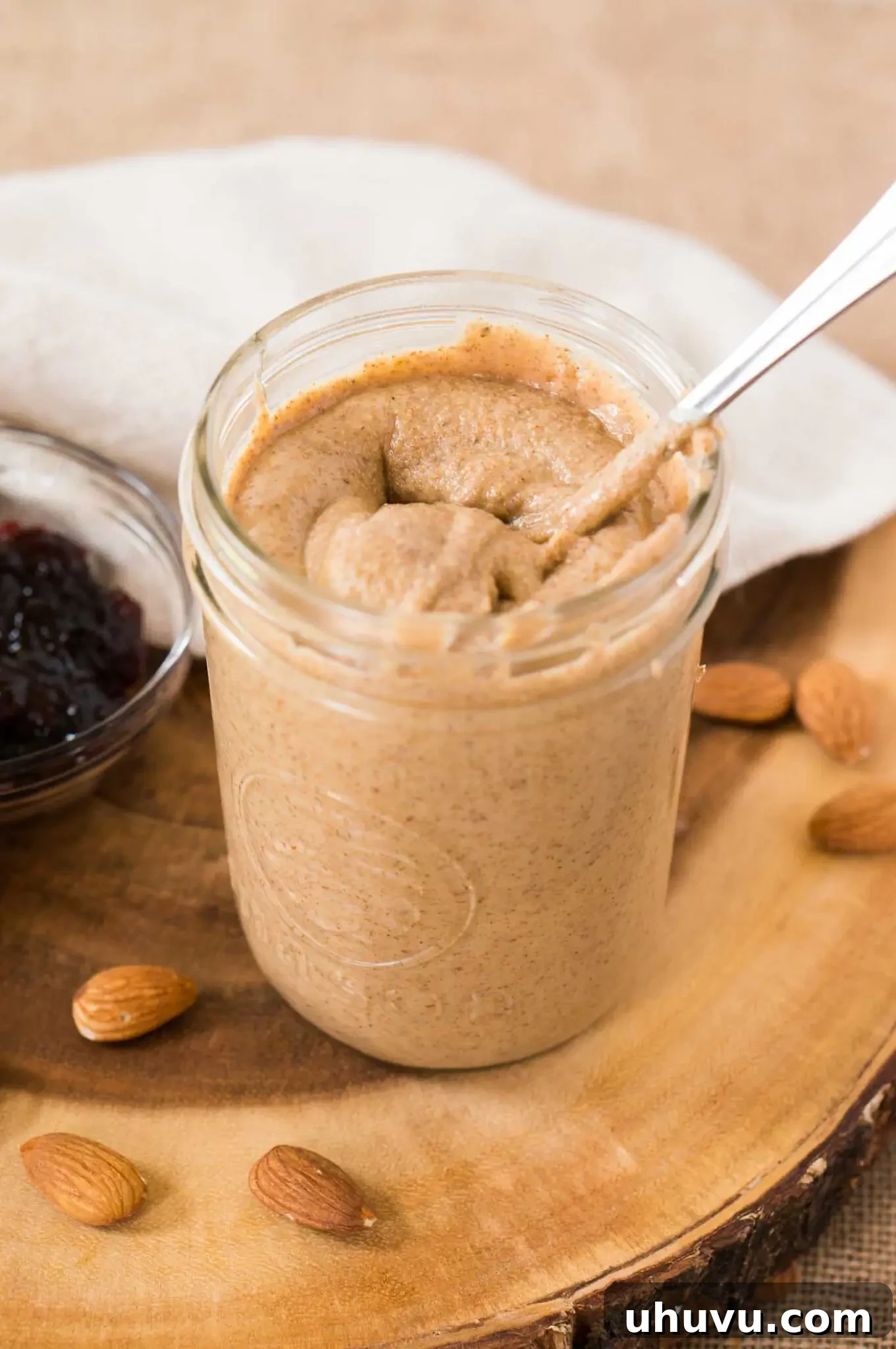 easy homemade almond butter in a jar with a spoon