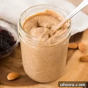 easy homemade almond butter in a jar with a spoon
