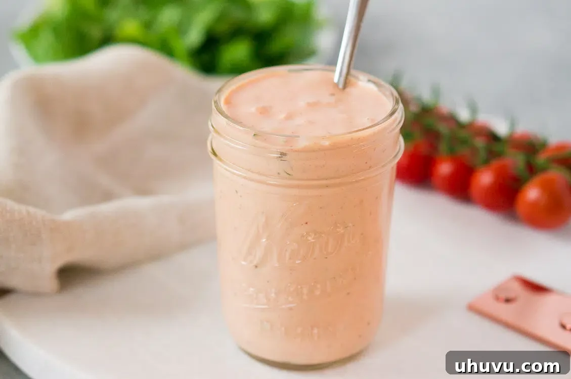Thousand Island dressing served with a fresh salad, highlighting its use as a vibrant topping.