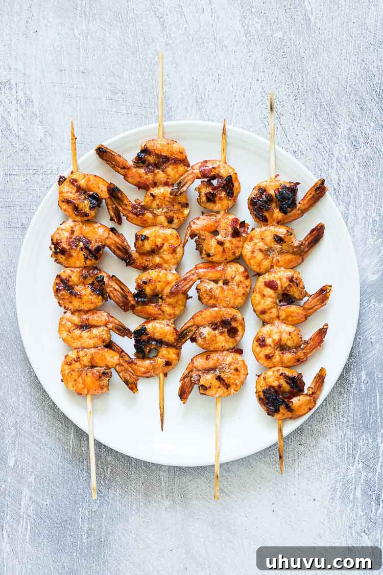 shrimp skewers on a white plate