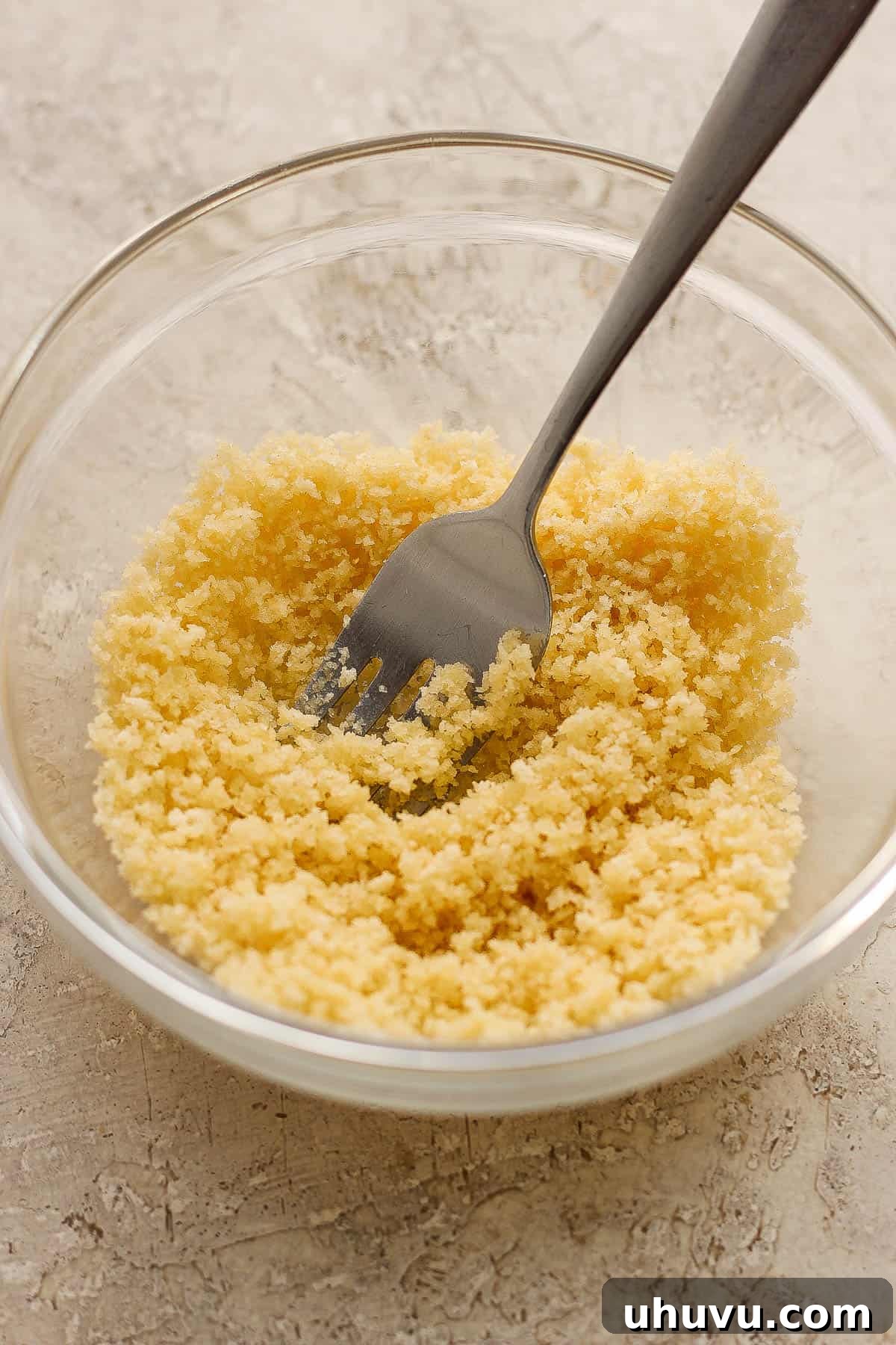 Crispy panko breadcrumbs mixed with melted butter in a bowl.