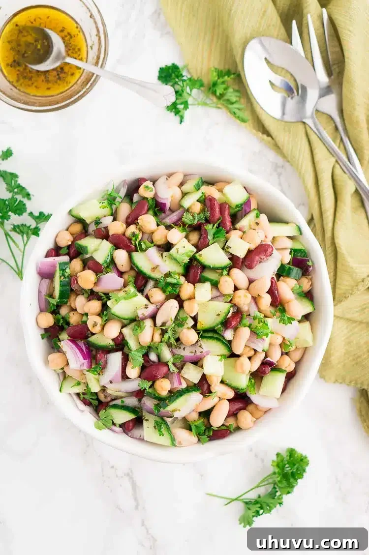 A vibrant and colorful top shot of three bean salad in a bowl, showcasing fresh ingredients.