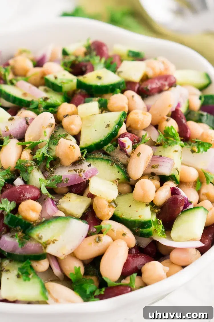 A close-up shot of the fresh ingredients for three bean salad, emphasizing their vibrant colors and textures.