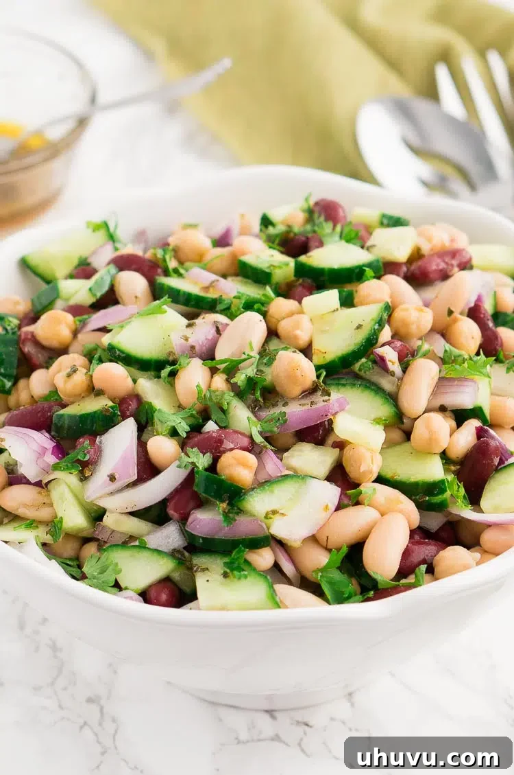 A refreshing three bean salad in a glass bowl, showcasing the vibrant colors and fresh ingredients.