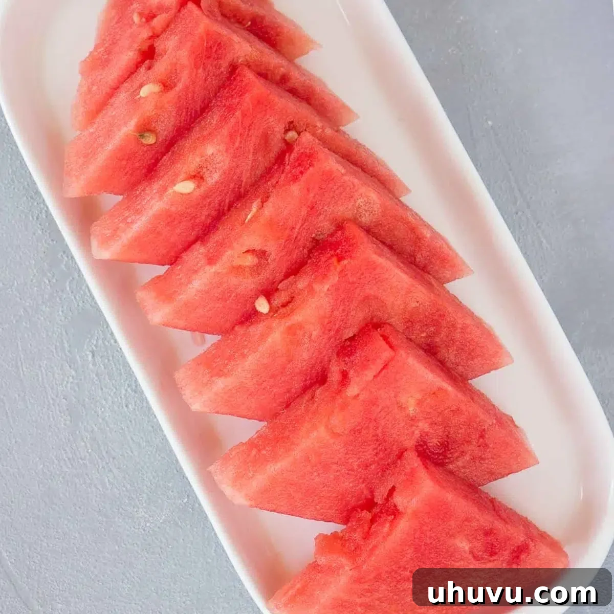 A plate piled high with juicy watermelon wedges, perfect for sharing.