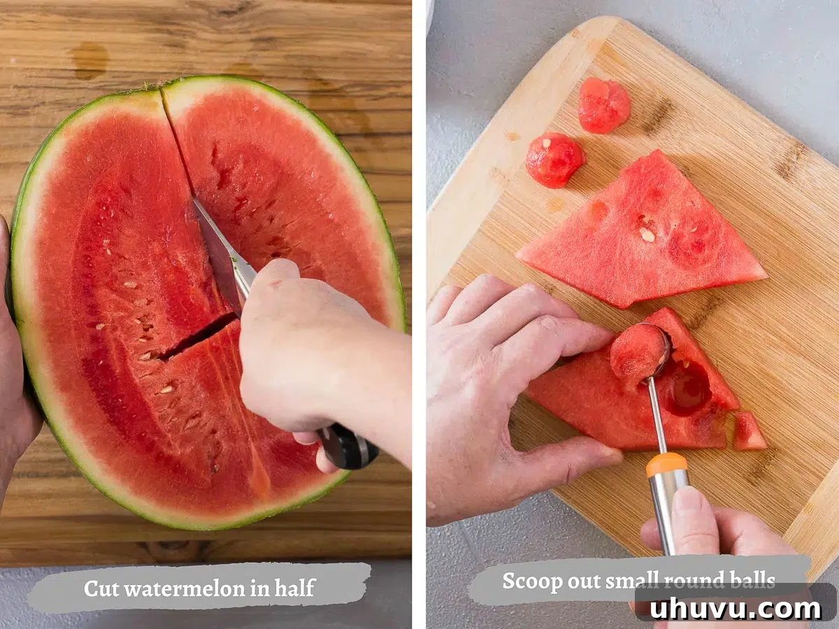 A hand using a melon baller to scoop perfect spheres from a halved watermelon.