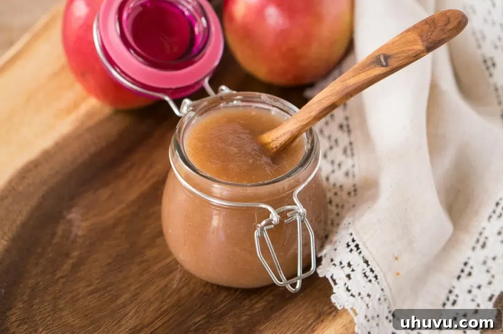 Canned homemade applesauce in glass jars, ready for storage.