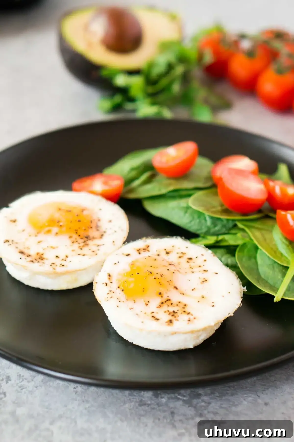 Golden Baked Eggs 7 muffin tin baked eggs on a plate with avocado and fruit