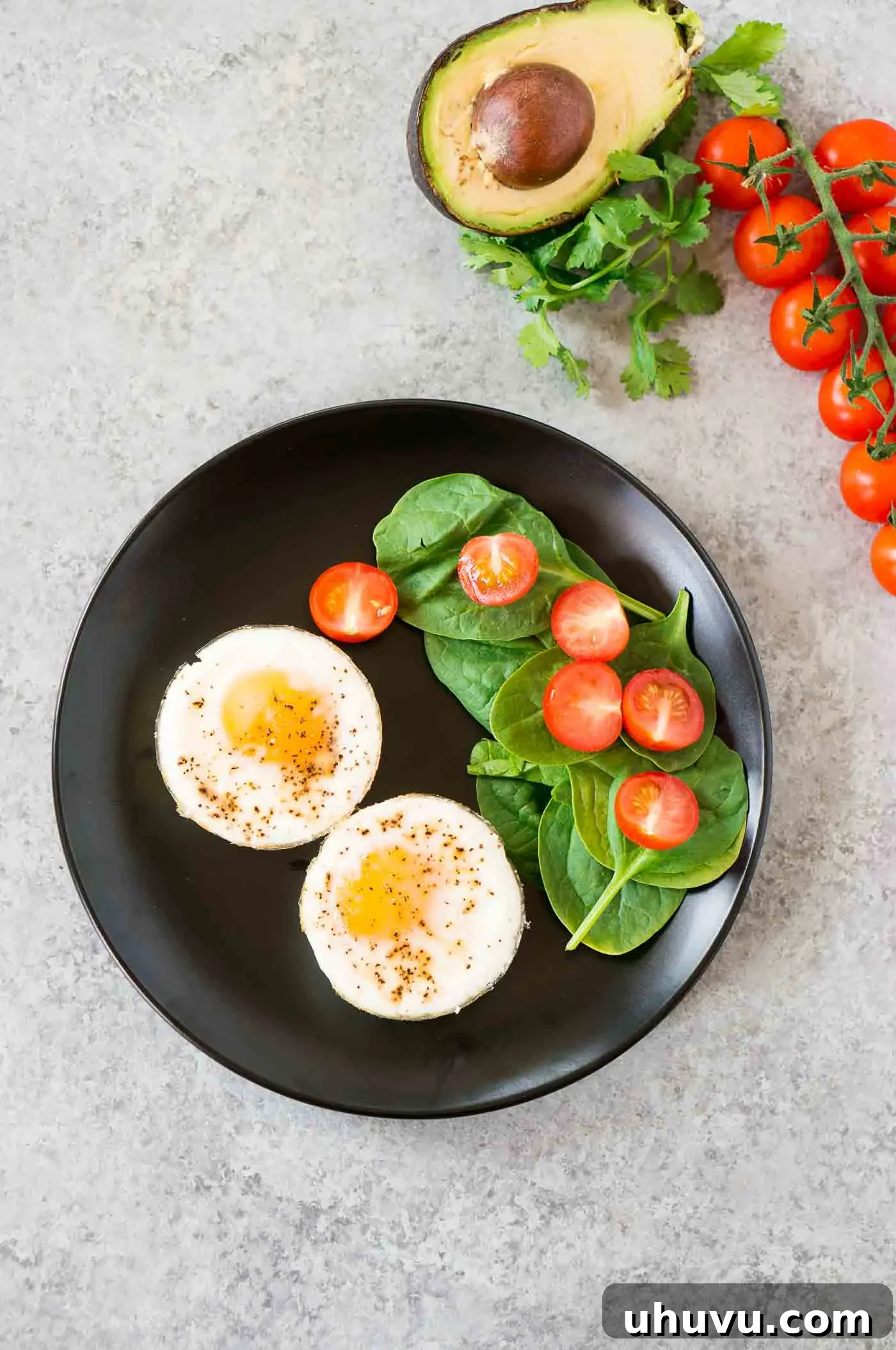 oven baked eggs on a plate with vegetables and herbs