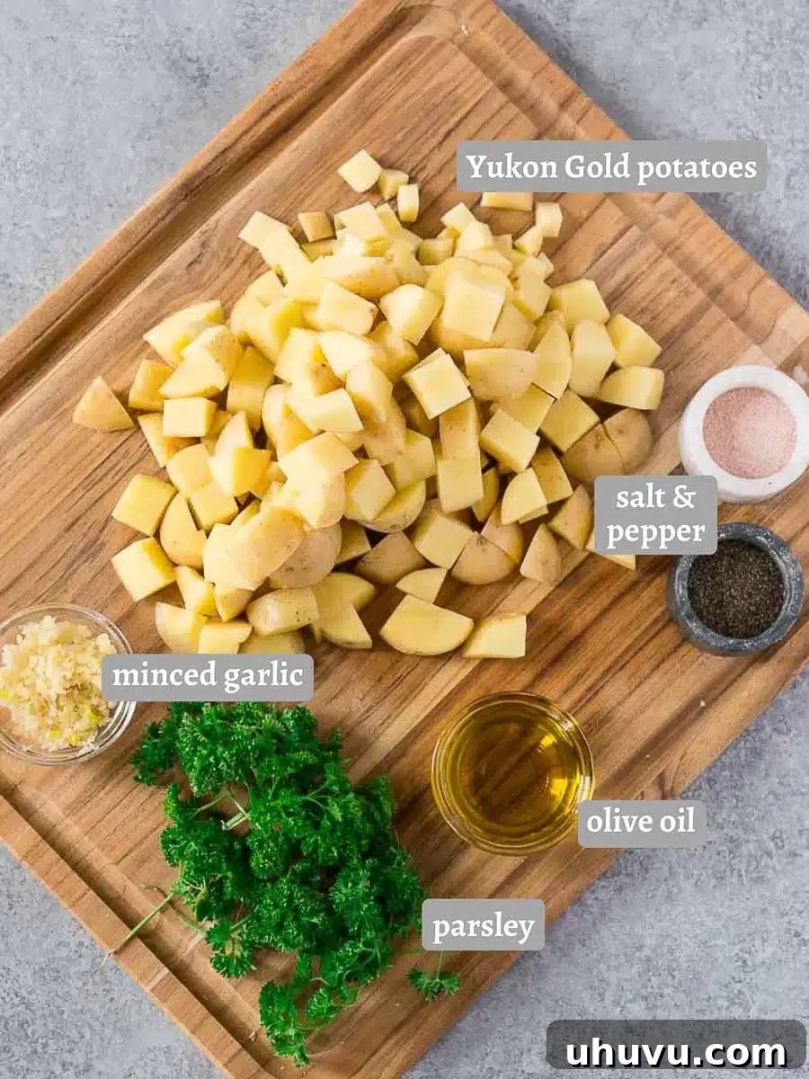 Ingredients for oven roasted potatoes, including Yukon Gold potatoes, olive oil, garlic, salt, pepper, and fresh parsley