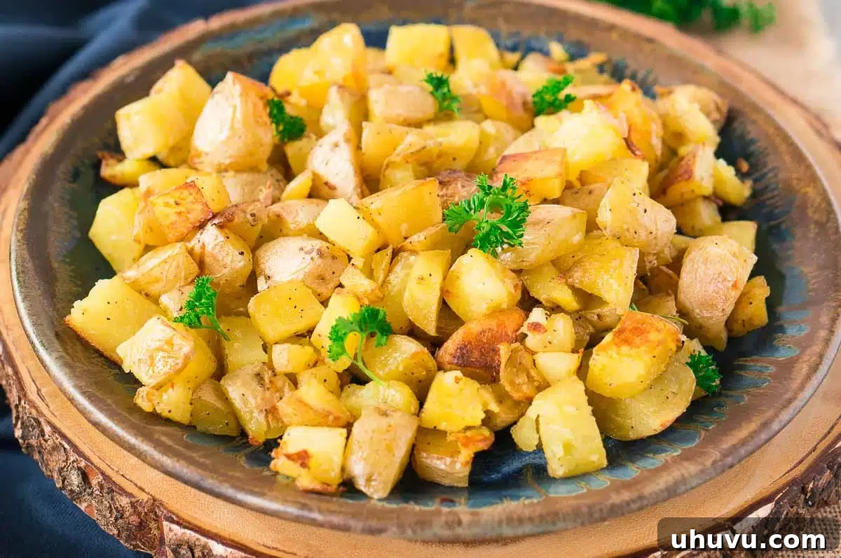 Close-up of crispy garlic roasted potatoes with golden edges and fresh parsley garnish