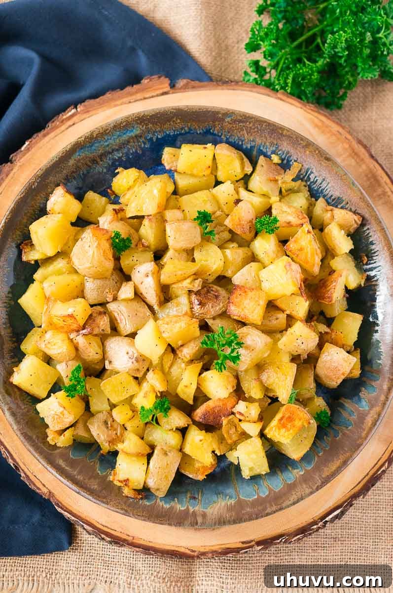 Golden Garlic Roasted Potatoes 6 Platter of delicious oven roasted potatoes garnished with fresh herbs, ready to serve alongside a main course