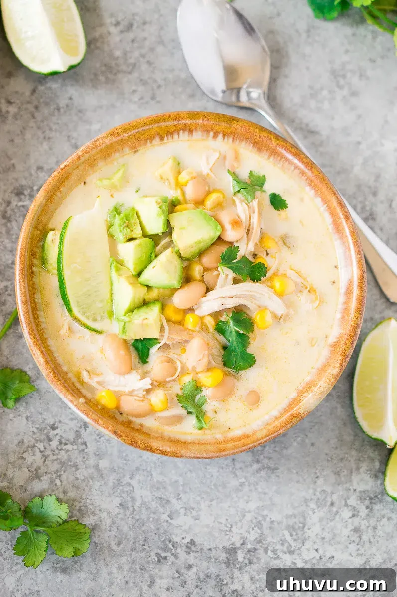 instant pot white chicken  chili recipe in a bowl with avocado slices