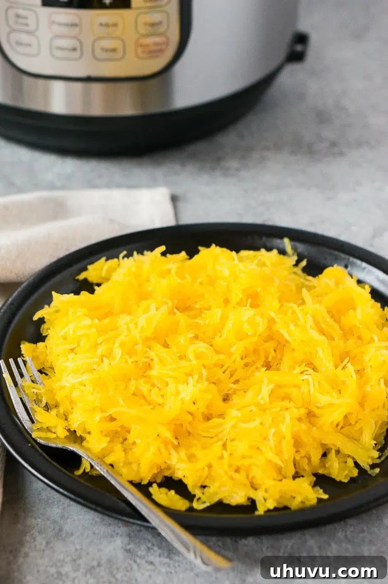 Instant Pot spaghetti squash served on a black plate, ready to eat.