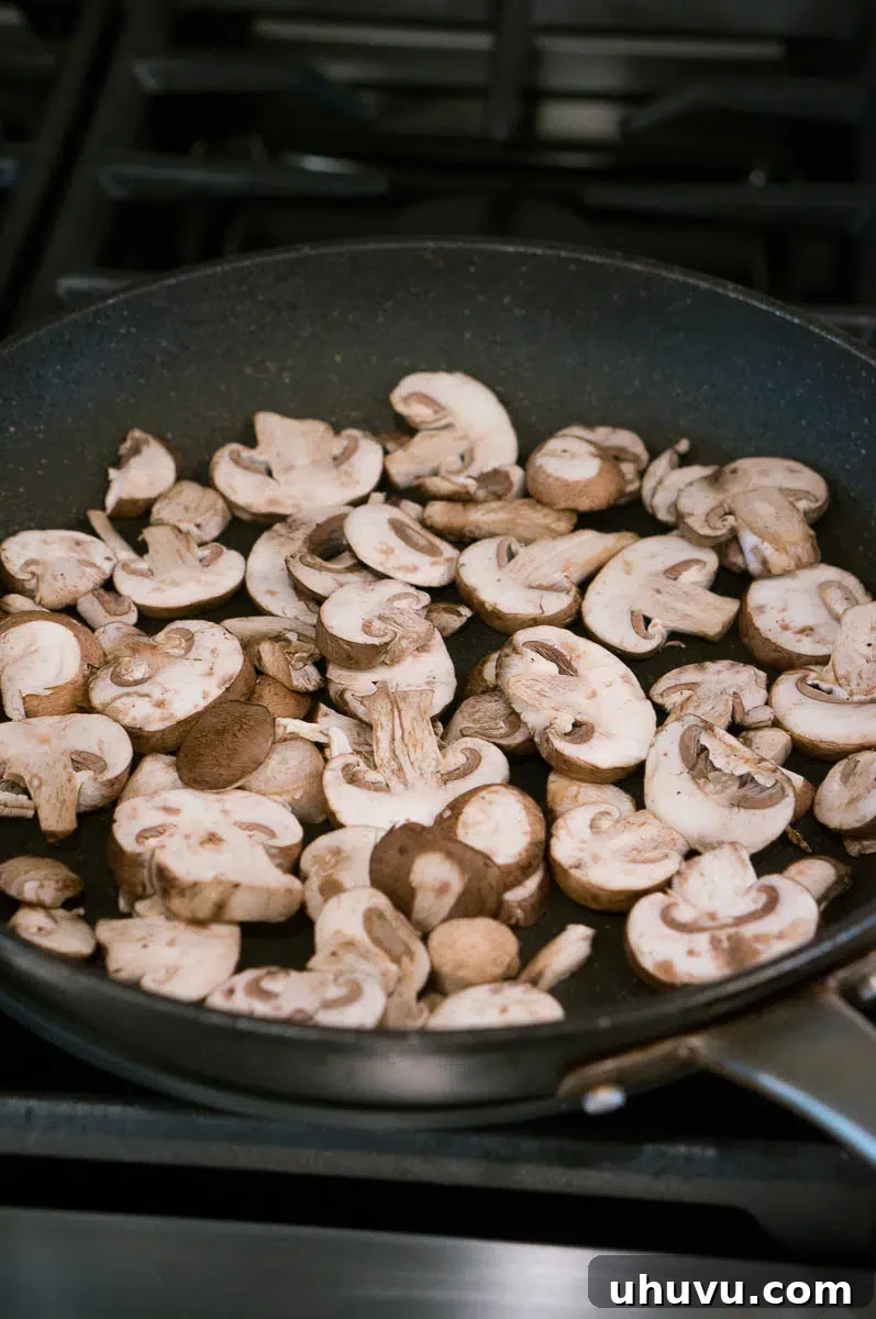 Mushrooms sauteeing in a pan