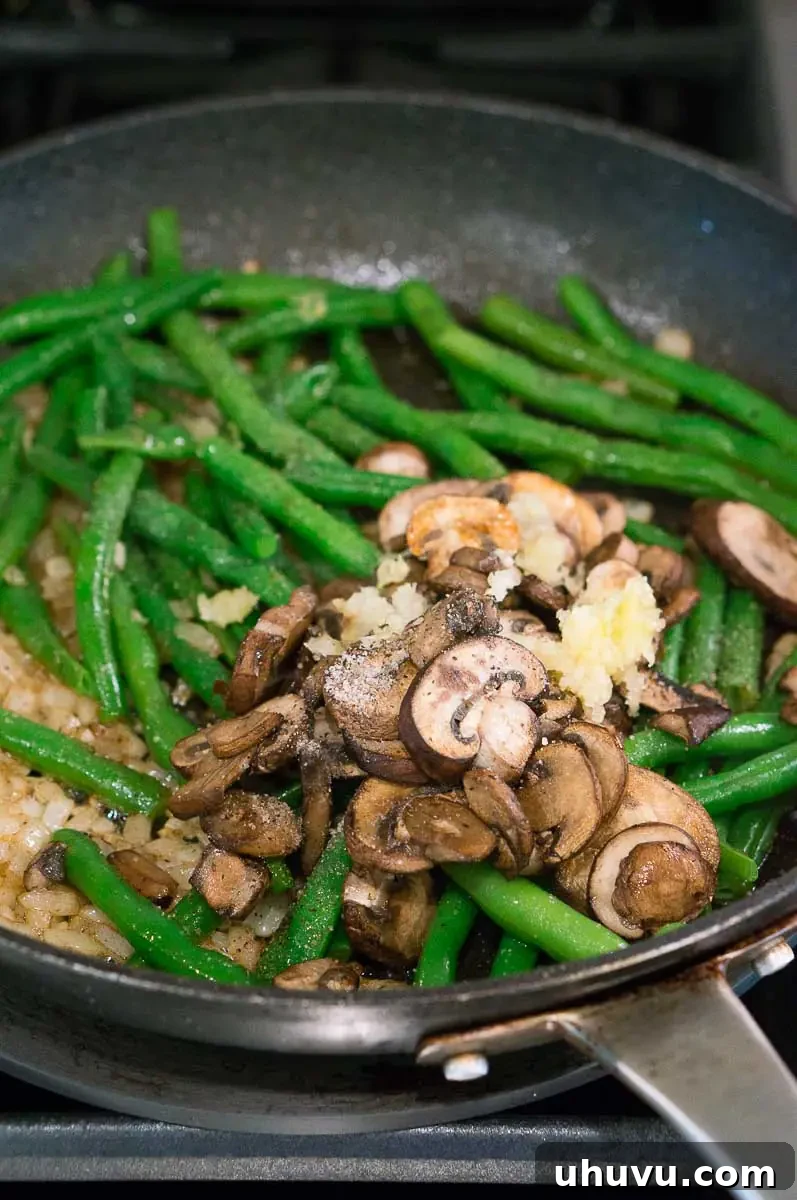 Cooked Green Beans, Mushrooms and onions in a skillet