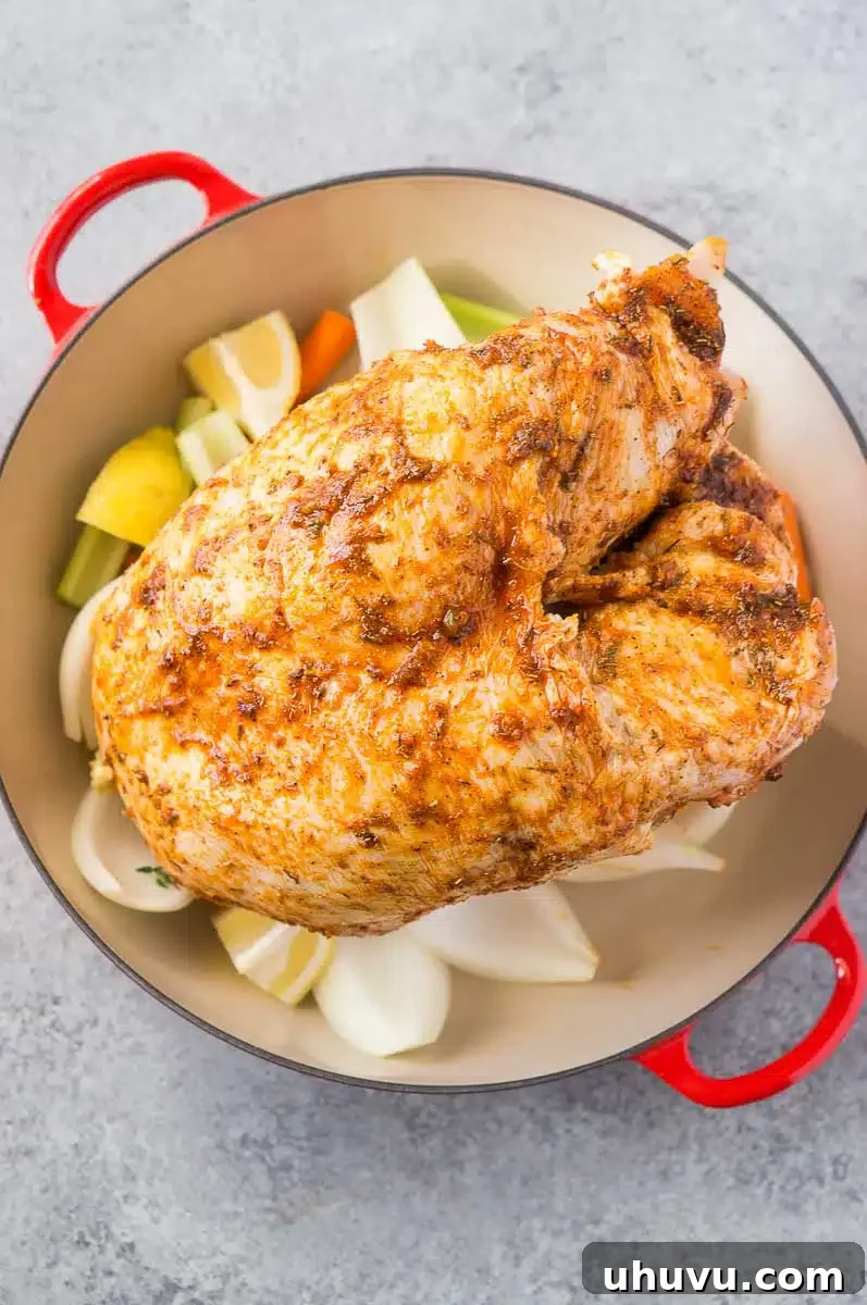Turkey breast over vegetables in a roasting pan