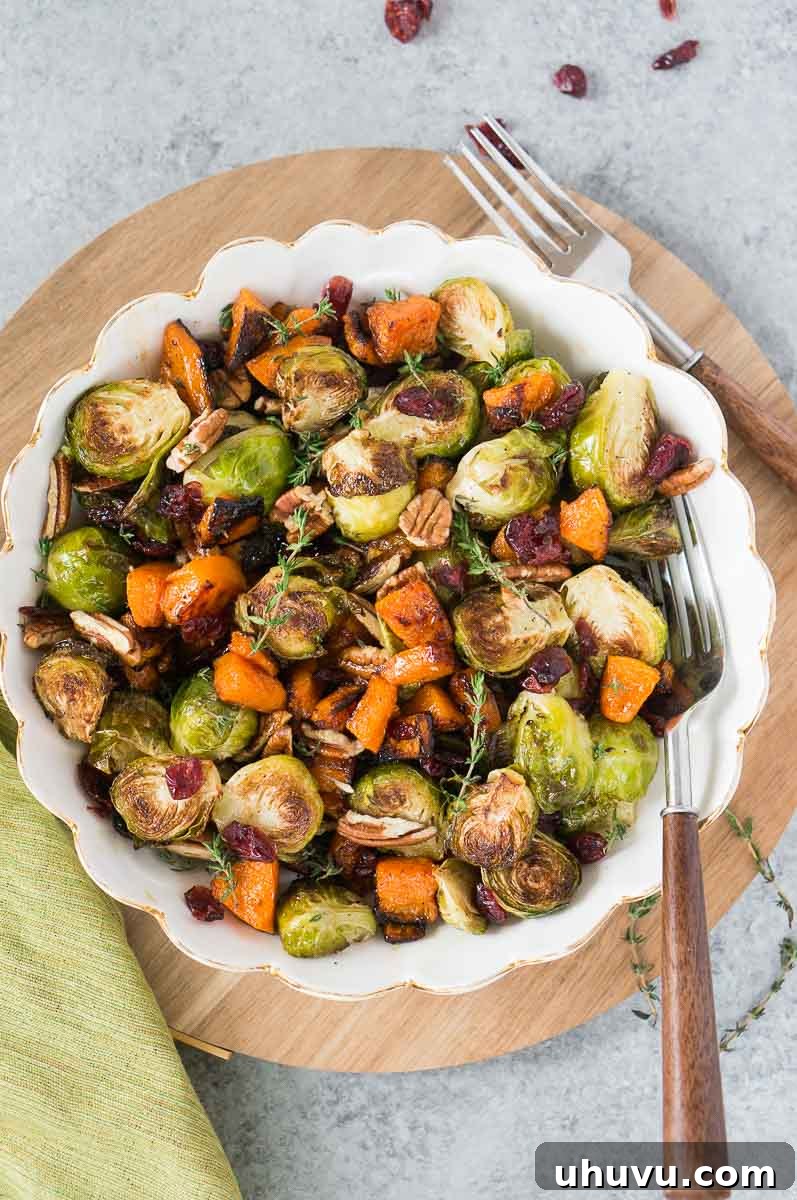 Caramelized Butternut Squash with Crispy Brussels Sprouts 2 roasted butternut squash and brussel sprouts for thanksgiving in a white bowl