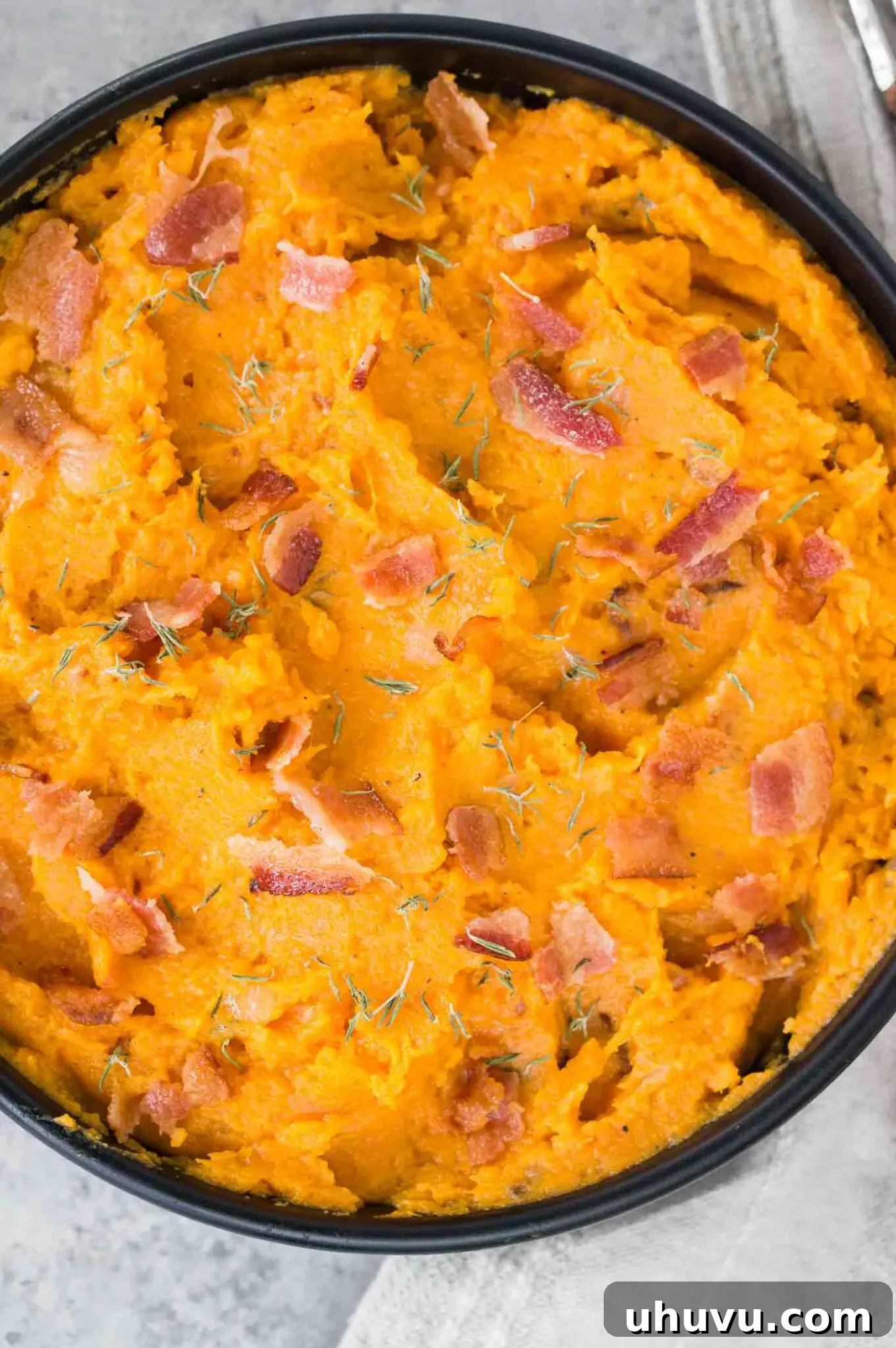 Sweet Potato Bacon Mash 8 close up image of mashed sweet potatoes in a black bowl