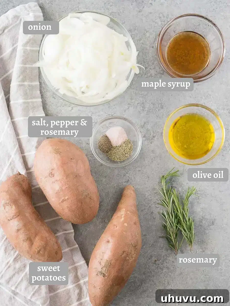 A collection of ingredients for rosemary roasted sweet potatoes and onions on a wooden board