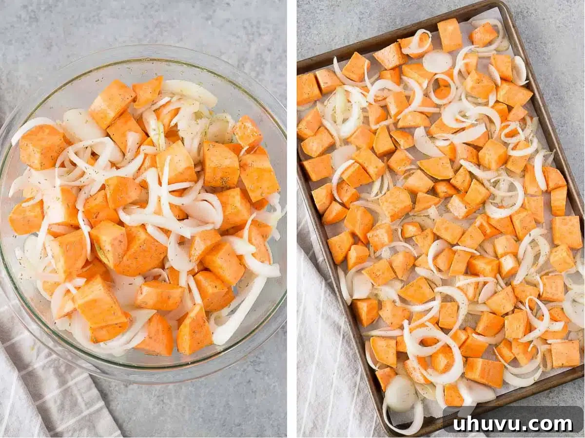 Hands tossing roasted sweet potatoes and onions on a baking sheet, illustrating the preparation process