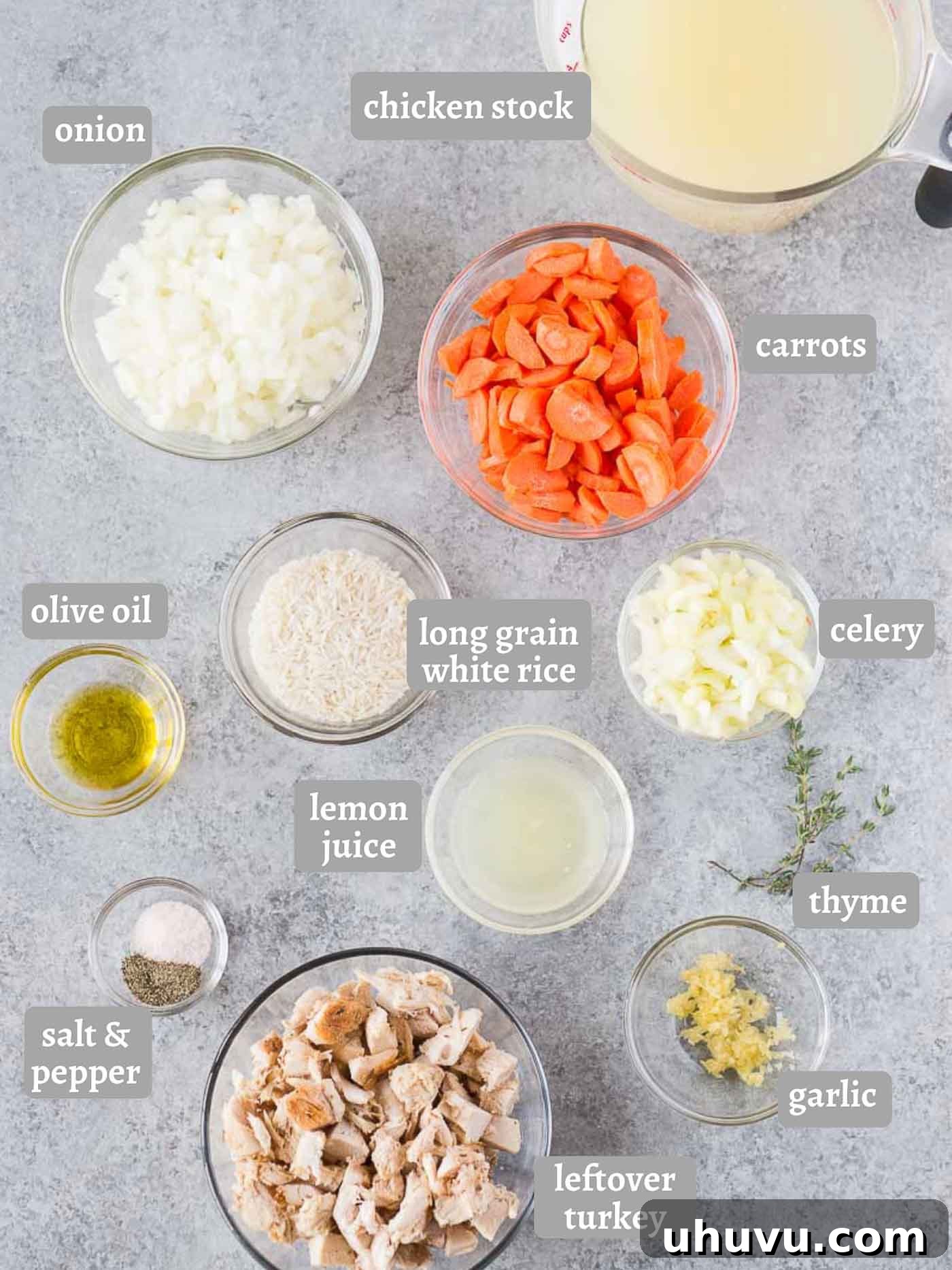 Savory Turkey Rice Comfort 4 Assortment of fresh ingredients for turkey rice soup, including shredded turkey, carrots, celery, onion, garlic, thyme, and a lemon, arranged on a rustic wooden board