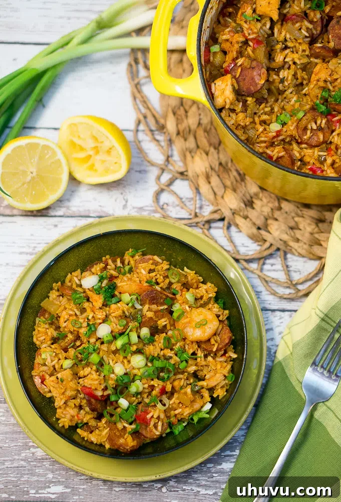 Mastering Jambalaya 2 Jambalaya served in a green bowl with sliced green onions, inviting and delicious.