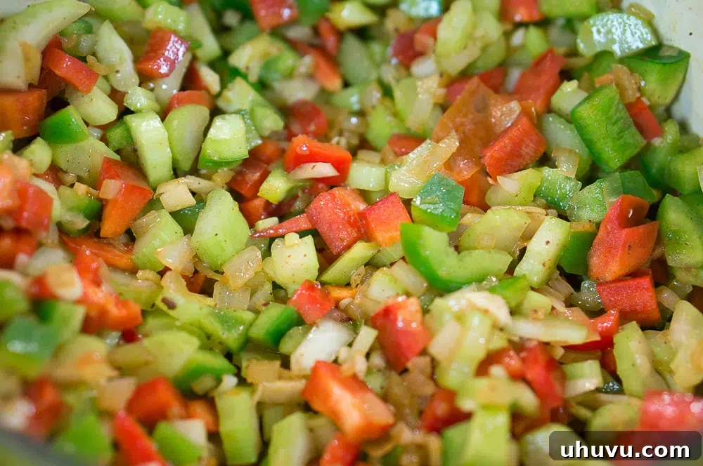 Mastering Jambalaya 5 Fresh vegetables sautéing in a hot pan, releasing their fragrant oils.