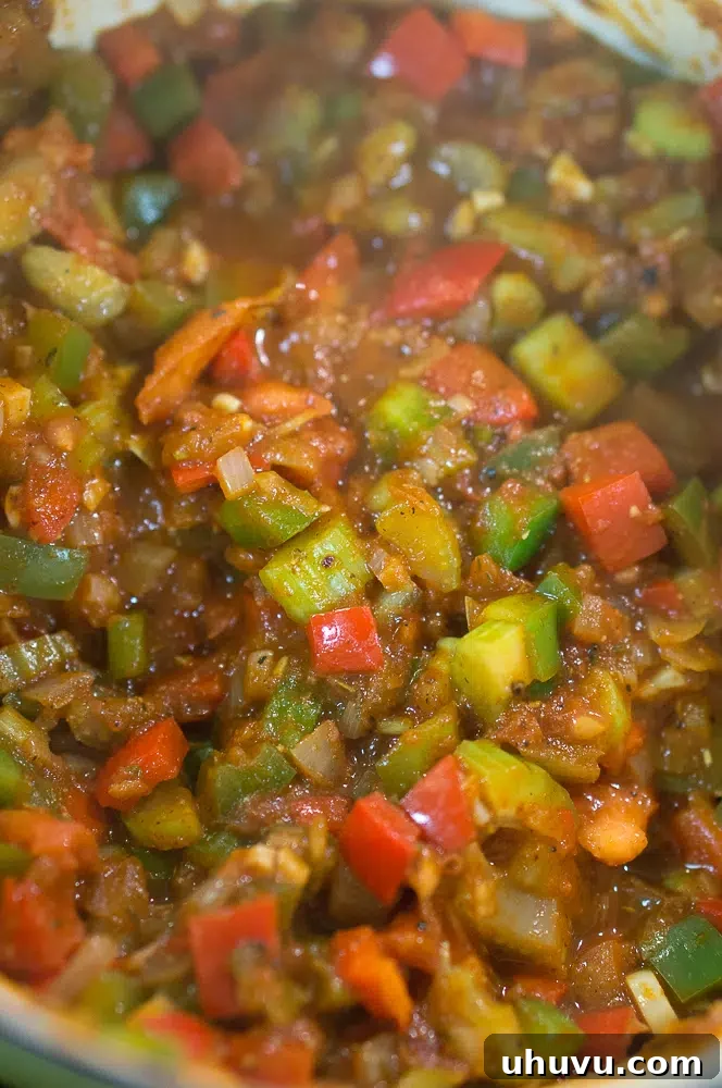 Mastering Jambalaya 6 A colorful mix of vegetables, spices, and tomato paste, creating a rich base.