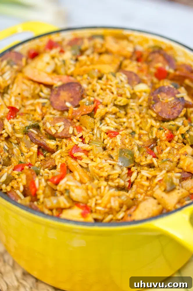 Mastering Jambalaya 8 The simmering, aromatic cooked Jambalaya filling a rustic Dutch oven, ready to be served.
