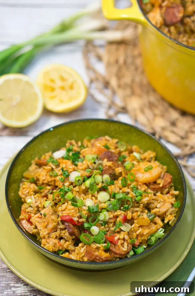 Mastering Jambalaya 9 A vibrant bowl of Jambalaya adorned with fresh herbs, ready to be enjoyed.