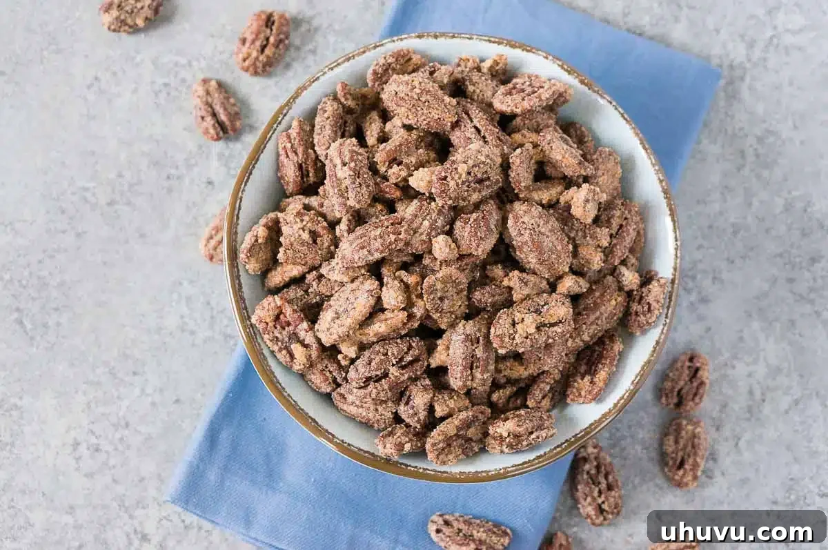 Homemade Candied Pecan Perfection 3 cinnamon sugar pecans in a blue bowl