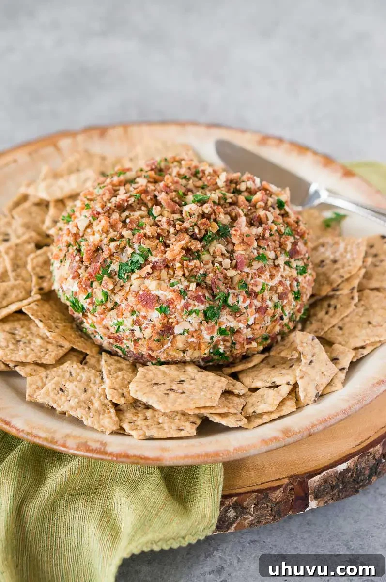 simple cheese ball with bacon pecan coating served with crackers