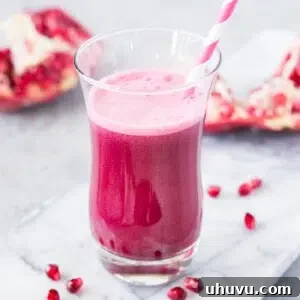 pomegranate juice in a glass with straw