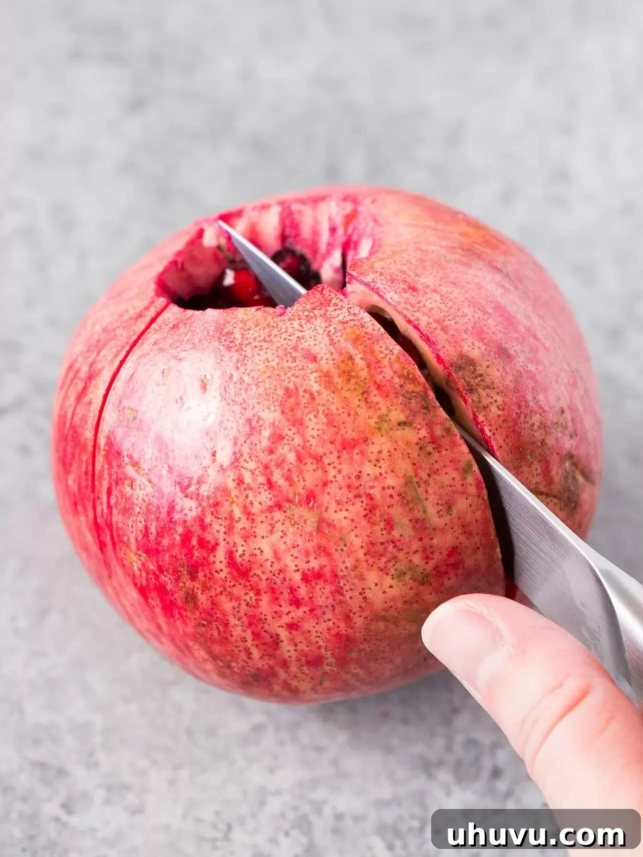 cutting a pomegranate along the ridges