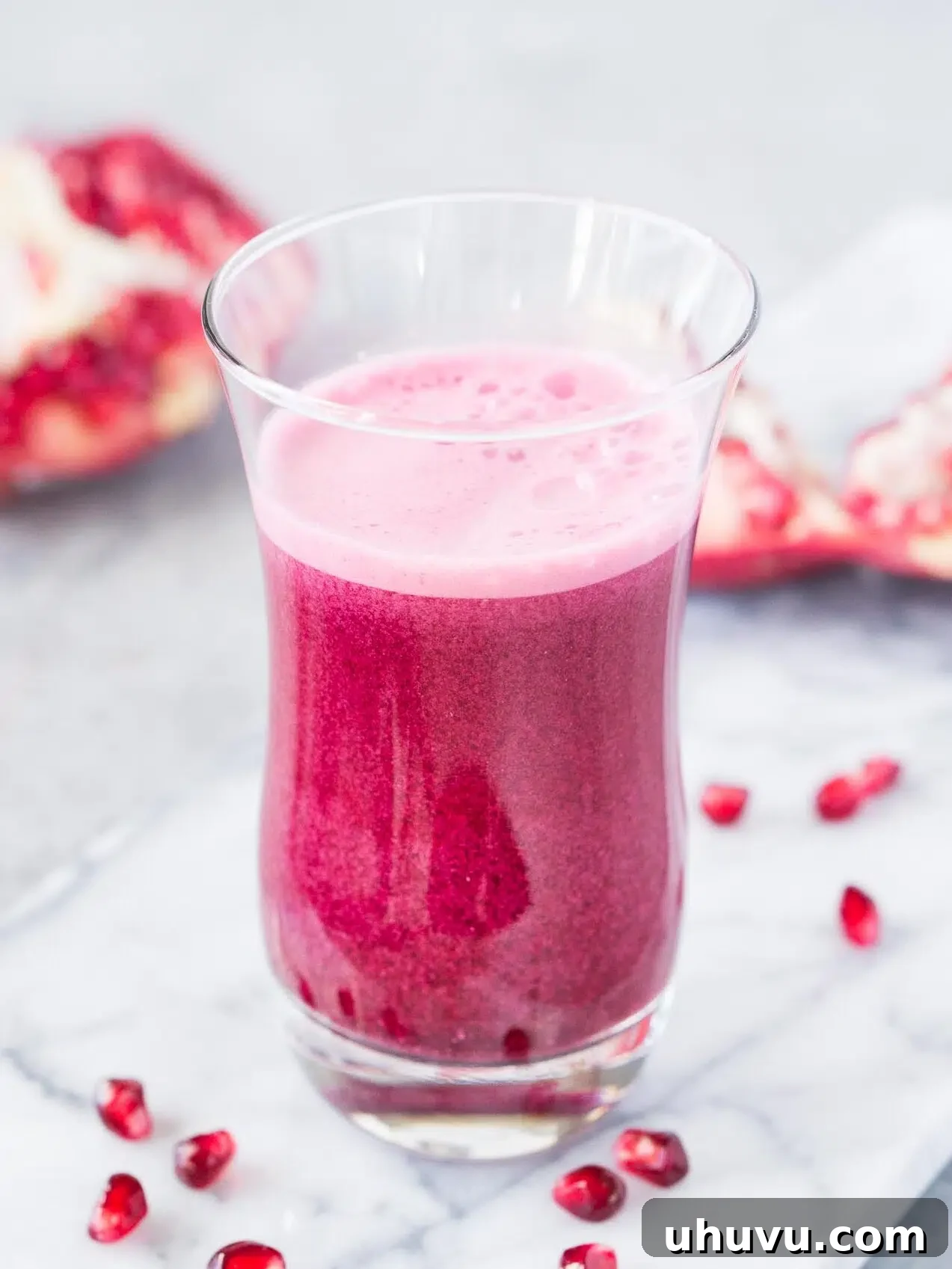 juiced pomegranate arils in a glass